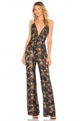 Chrissy Teigen X REVOLVE THAI SMILE JUMPSUIT in Black – plunging lace jumpsuits