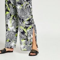 RIVER ISLAND Black floral print pleated wide leg trousers / side split hem pants