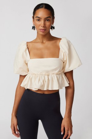 UO Lara Cropped Babydoll Blouse in White | strappy back crop hem peplum blouses | puff sleeve frill hemline tops