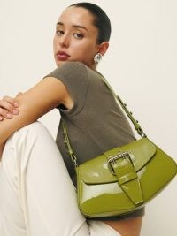Reformation Rafaella Shoulder Bag in Salamander Patent | luxe handbags | glossy green leather bags | front buckle detail