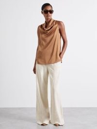 Manon Atelier Satin Cowl-Neck Top in Tan / women’s silky sleeveless draped neckline tops