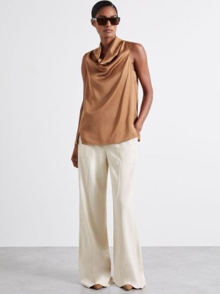 Manon Atelier Satin Cowl-Neck Top in Tan / women’s silky sleeveless draped neckline tops