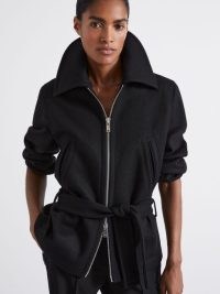 REISS Atelier Ada Virgin Wool-Blend Belted Coat in Black ~ collared tie waist short length coats ~ women’s chic zip up jacket