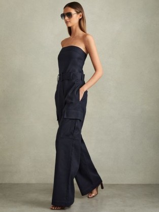 REISS Lois Strapless Belted Wide Leg Jumpsuit in Navy – chic dark blue bandeau neckline cargo style jumpsuits – utility inspired occasion clothing