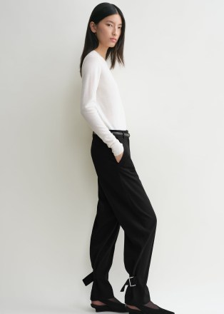 TOTEME Buckled slouch trousers in black ~ women’s chic slouchy buckle detail ankle tie trouser