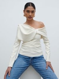 PRETTY LAVISH Naomi Exaggerated Bow Top in Cream | chic long sleeve one shoulder tops | asymmetric fashion