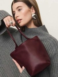 Reformation Dimitra Pouch Bag in Ruby Leather | dark red drawstring shoulder bags