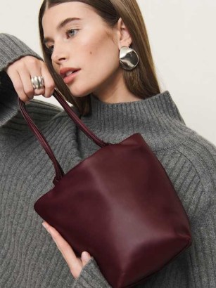 Reformation Dimitra Pouch Bag in Ruby Leather | dark red drawstring shoulder bags